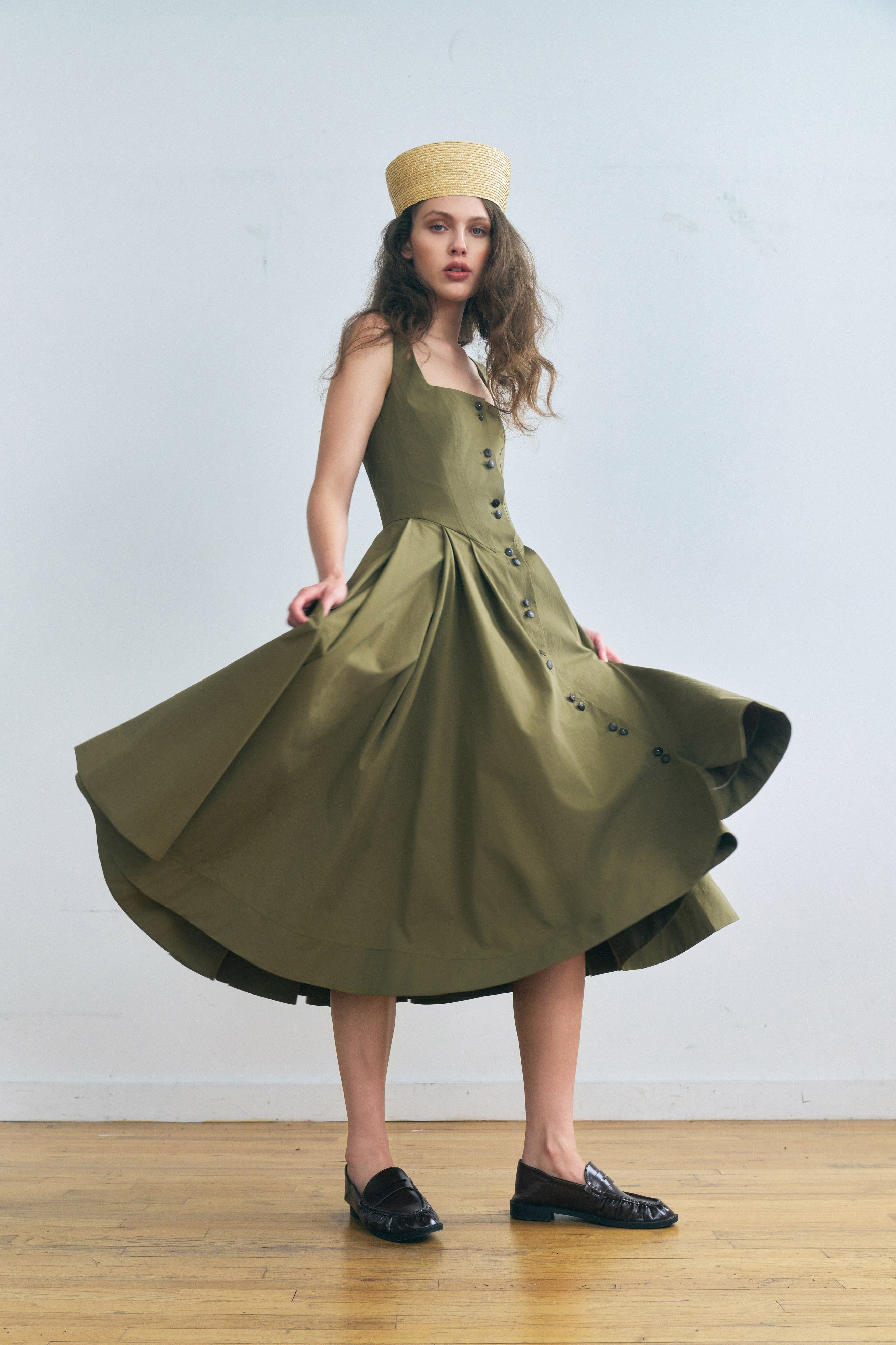 Toloache dress in Mosswood — Premium Japanese Cotton Blend, seamed bustier bodice, full A-line skirt, Italian carozo natural buttons, concealed back zipper closure, full-length front view with skirt in motion