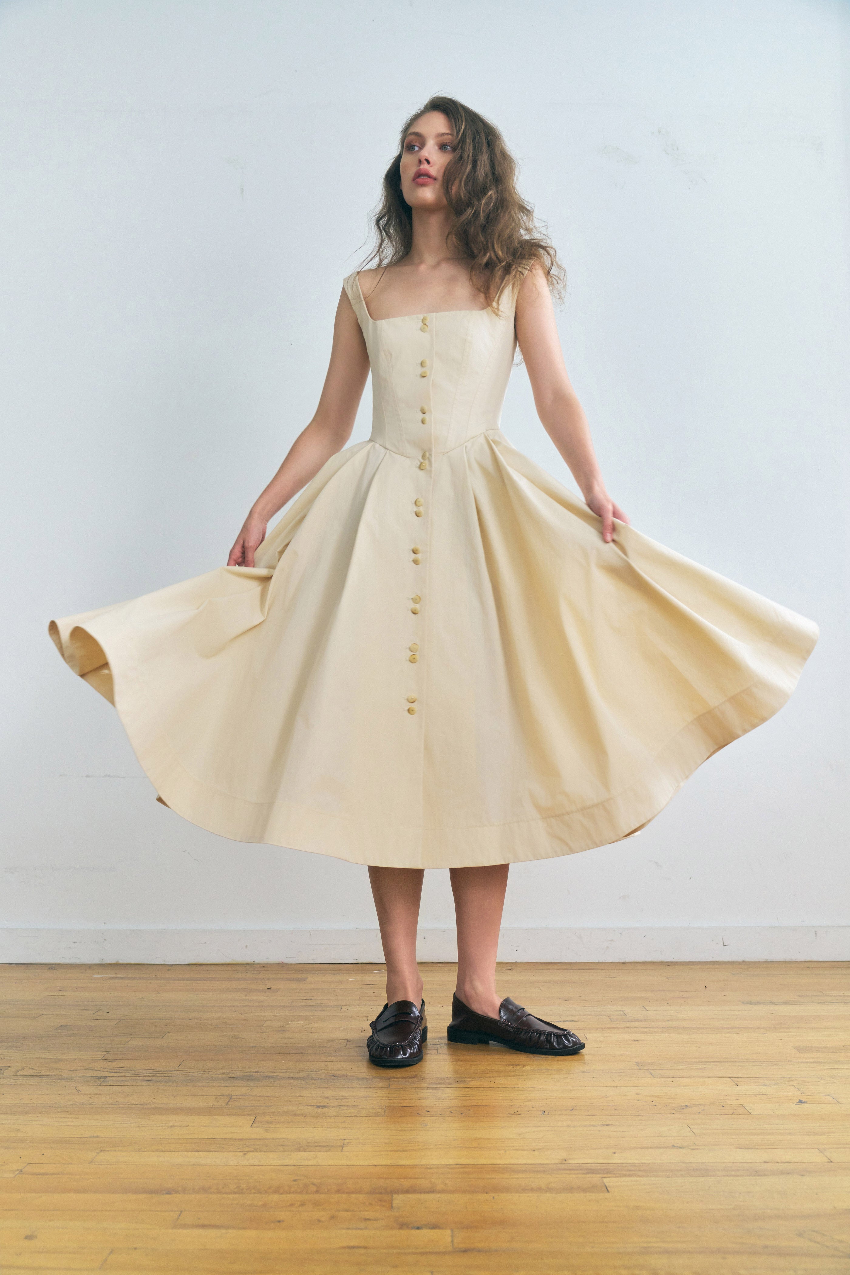 Toloache dress in Powder — Premium Japanese Cotton Blend, seamed bustier bodice, full A-line skirt, Italian carozo natural buttons, concealed back zipper closure, full-length front view skirt held wide