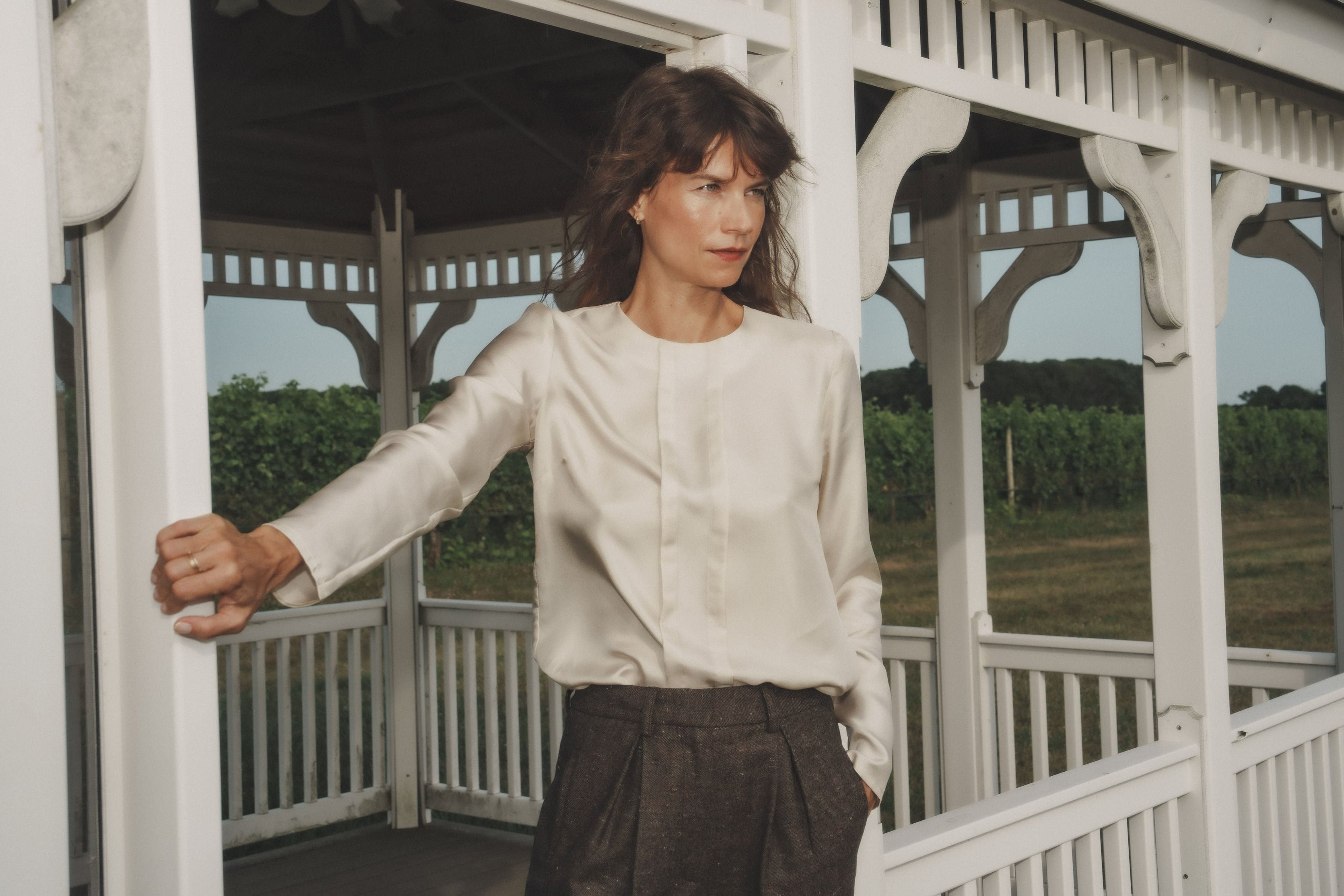 Choya top in Bone — lustrous silk twill, relaxed fit, long straight sleeves, pleated front details, side view