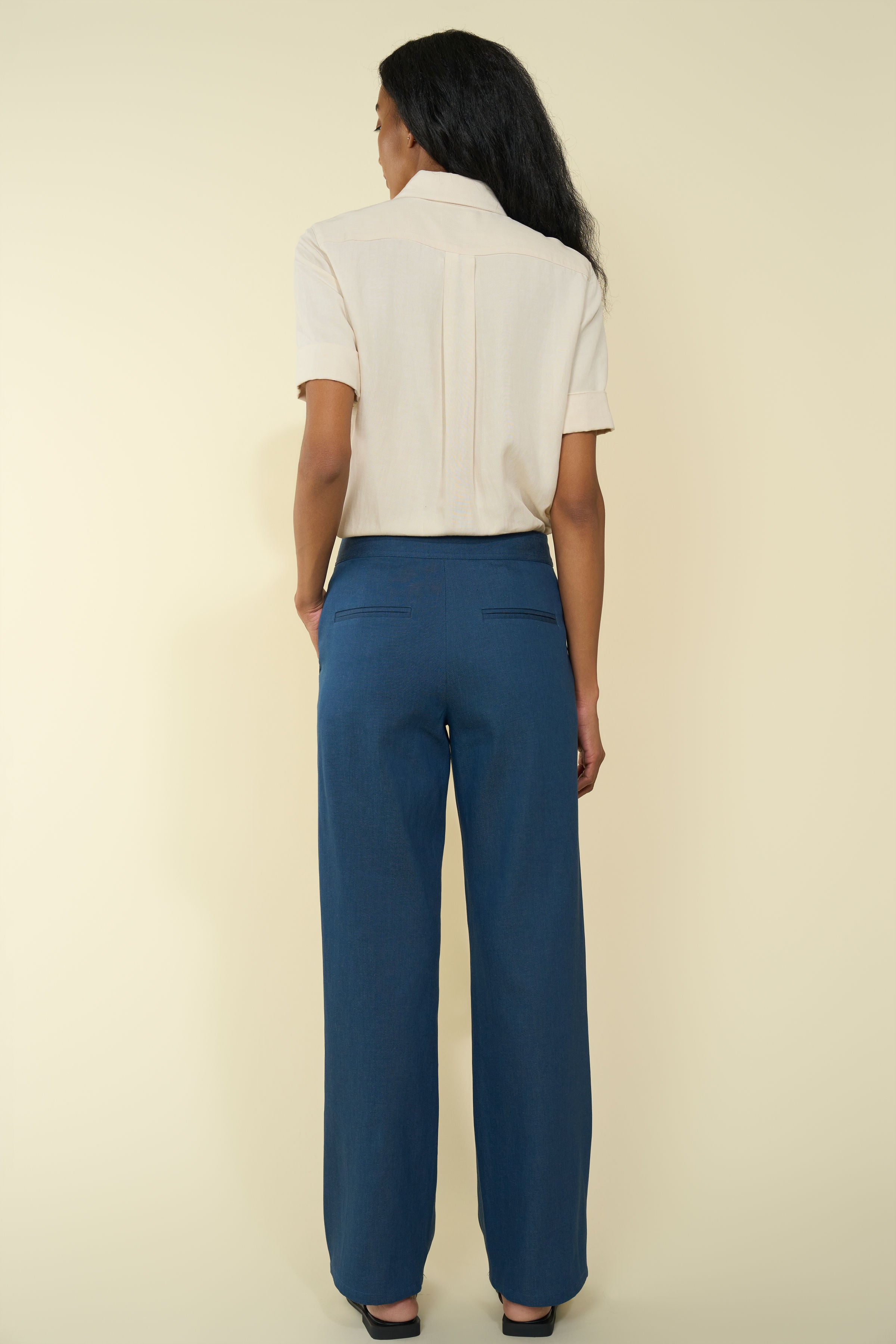 Hecho Pants in Indigo — premium Japanese denim, 70's-inspired style, front button details, mid-waist, wide leg, back view