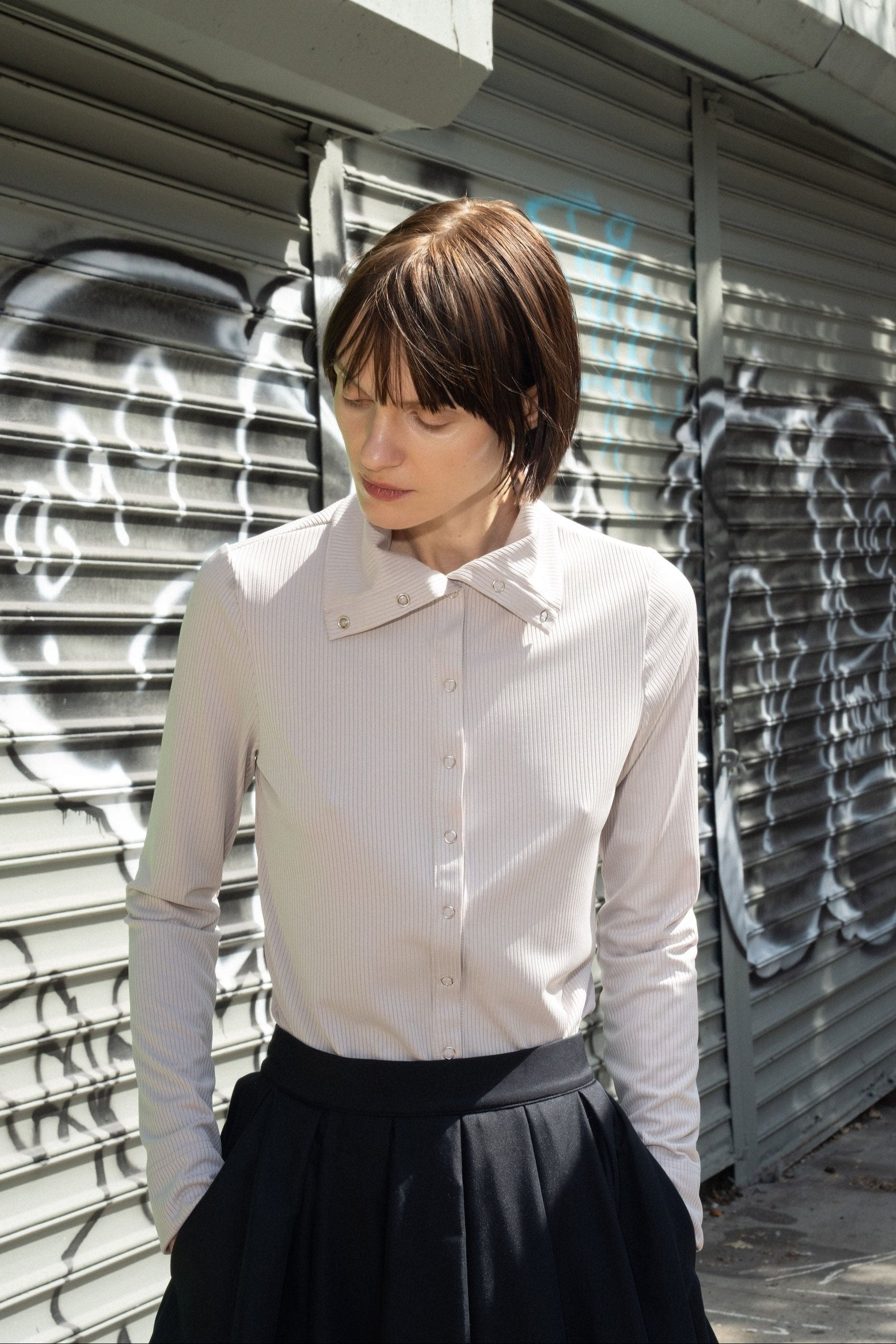 Papelillo ribbed top in Dove — ultra-sleek ribbed jersey, metal snap buttons full length, wearable as turtleneck or open collar, easy relaxed fit