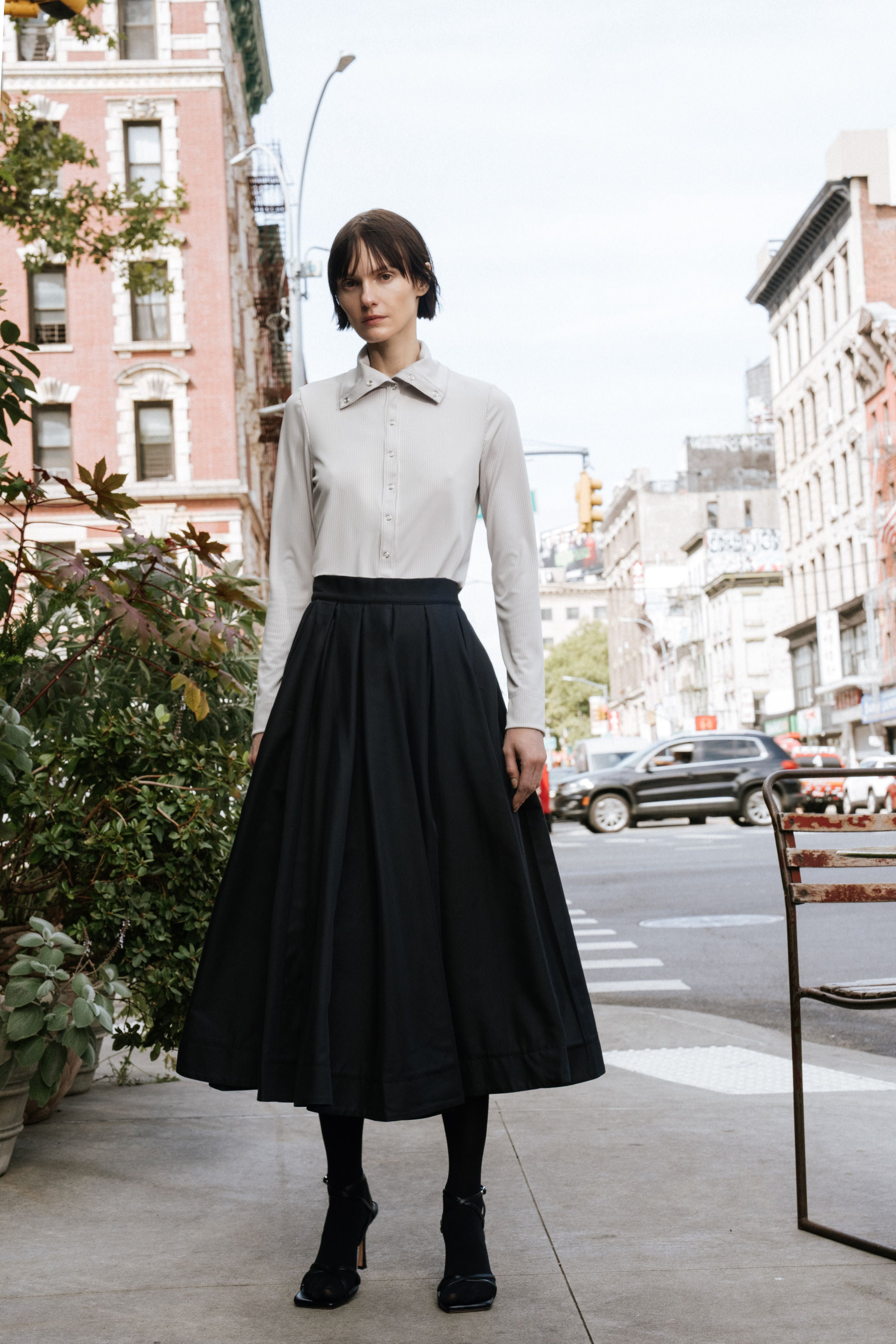 Papelillo ribbed top in Dove — ultra-sleek ribbed jersey, metal snap buttons full length, wearable as turtleneck or open collar, easy relaxed fit, full-length front view