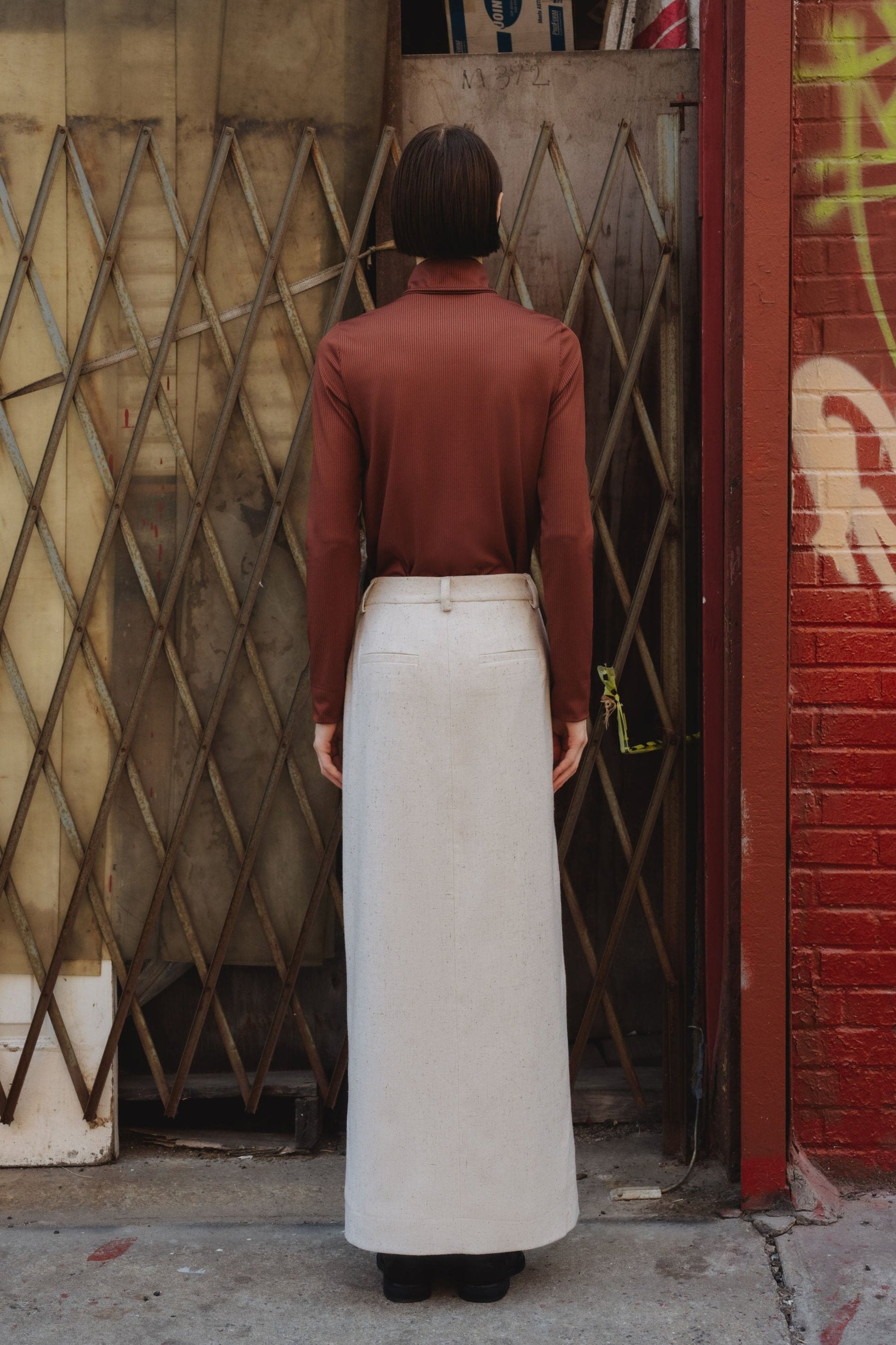 Papelillo ribbed top in Wine — ultra-sleek ribbed jersey, metal snap buttons full length, wearable as turtleneck or open collar, easy relaxed fit, full-length front view