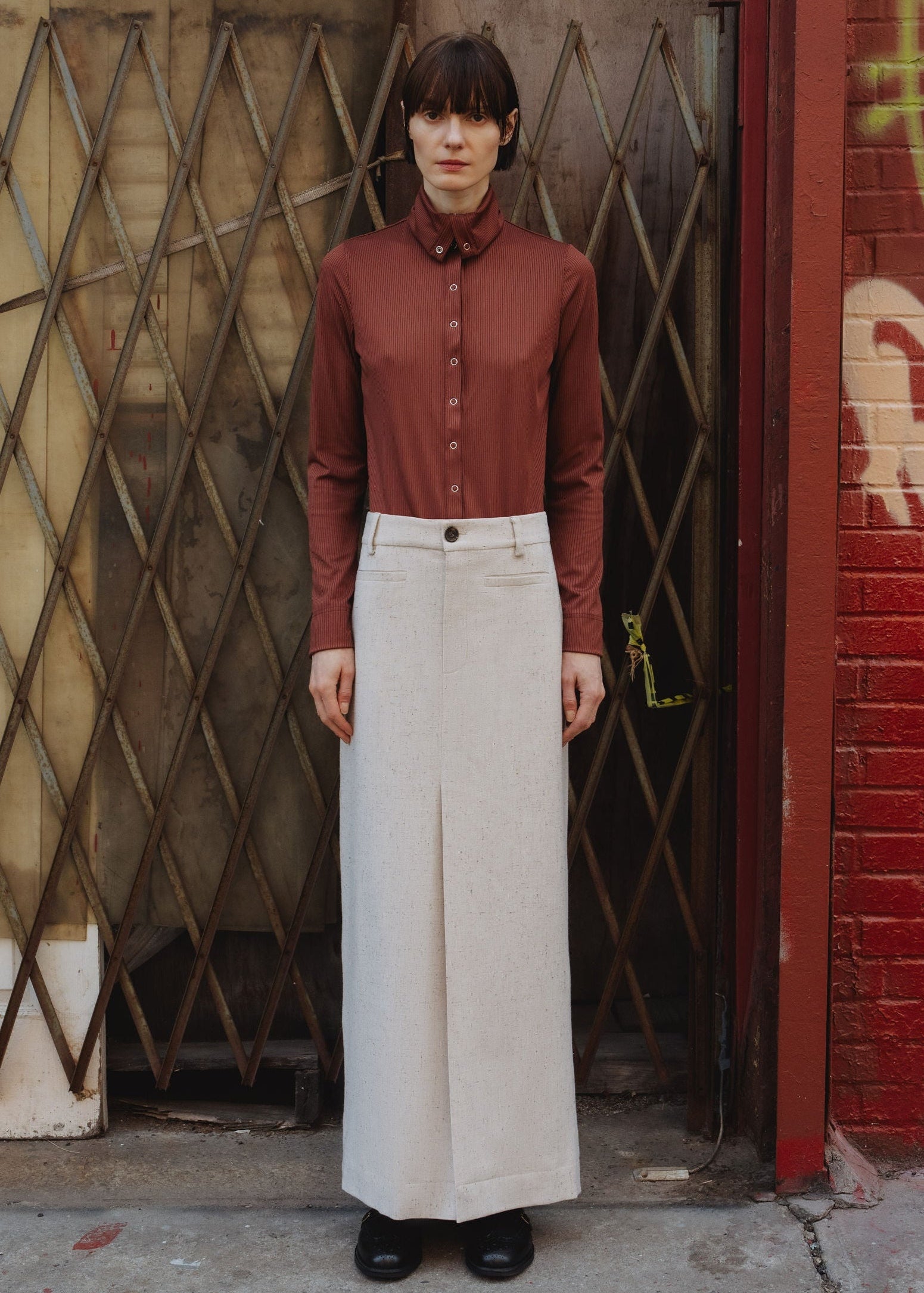 Papelillo ribbed top in Wine — ultra-sleek ribbed jersey, metal snap buttons full length, wearable as turtleneck or open collar, easy relaxed fit, front view