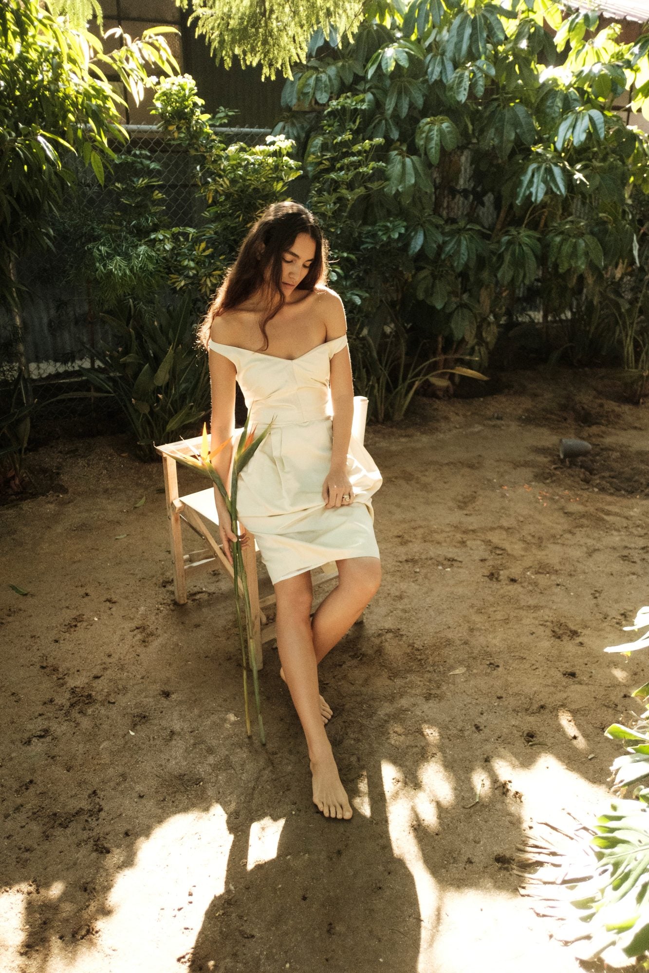 Woman wearing the Stathe Piloncillo Dress in Butter, outdoors — editorial