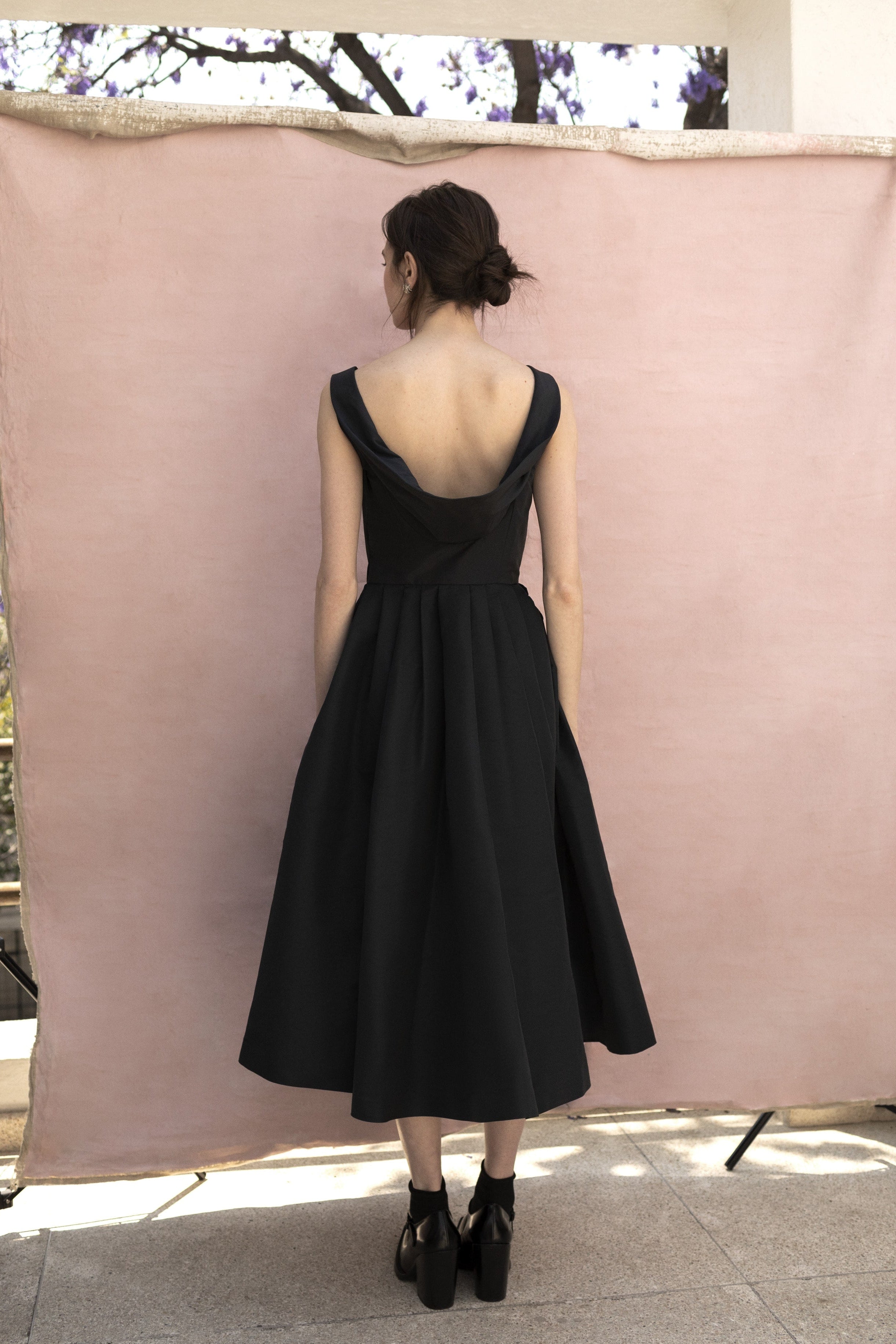 Pitahaya dress in Black — faille fabric, cowl back detail, full skirt above-ankle length, self-lined bodice, fully silk-lined skirt, hidden pockets, concealed side zip 