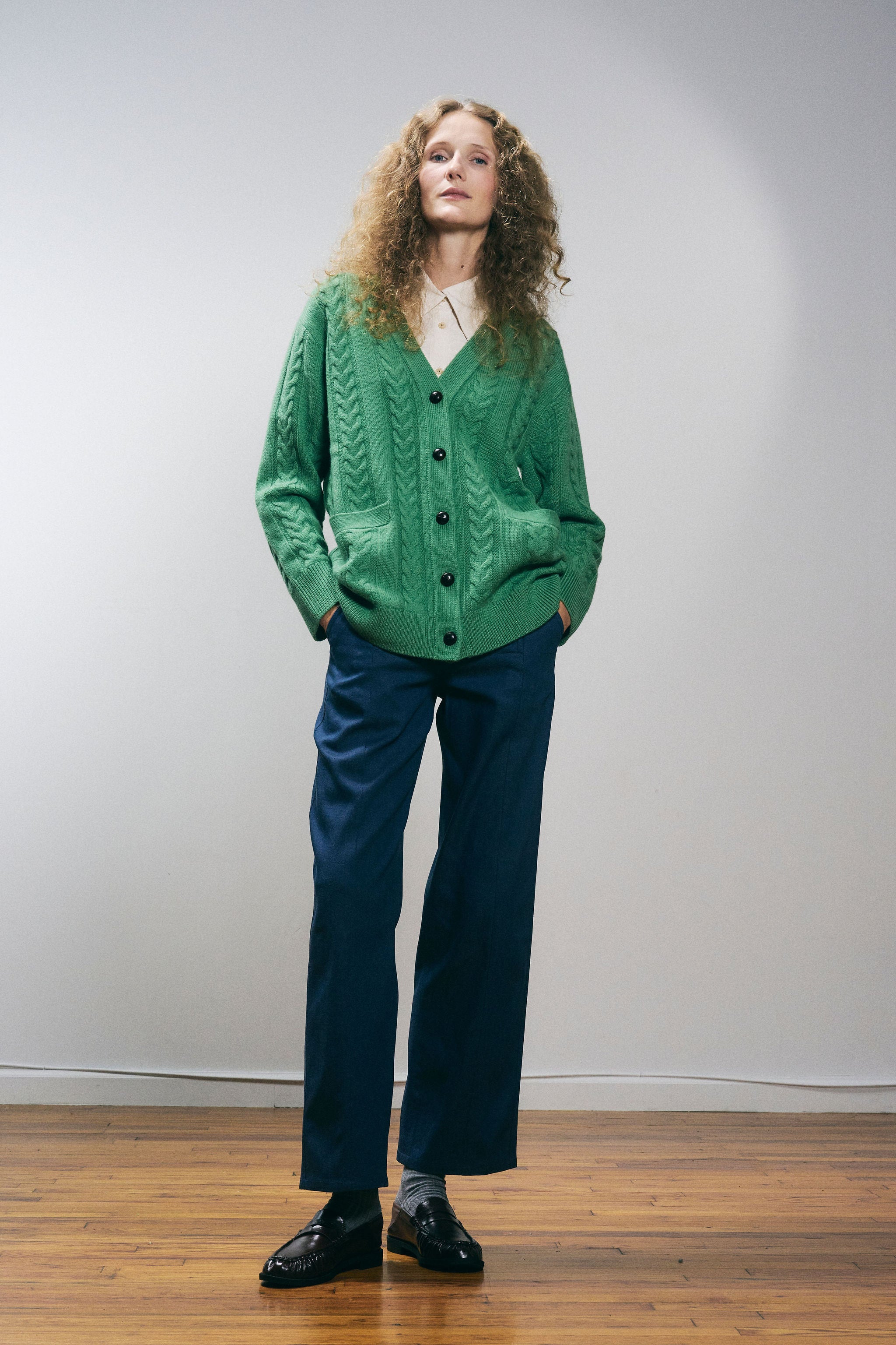 Sanmiguelito cardigan in Green — 100% Extrafine Merino wool, horseshoe cable and rib knit pattern, dropped shoulder, ribbed cuffs and hem, dark brown leather buttons, below-waist length, front full view