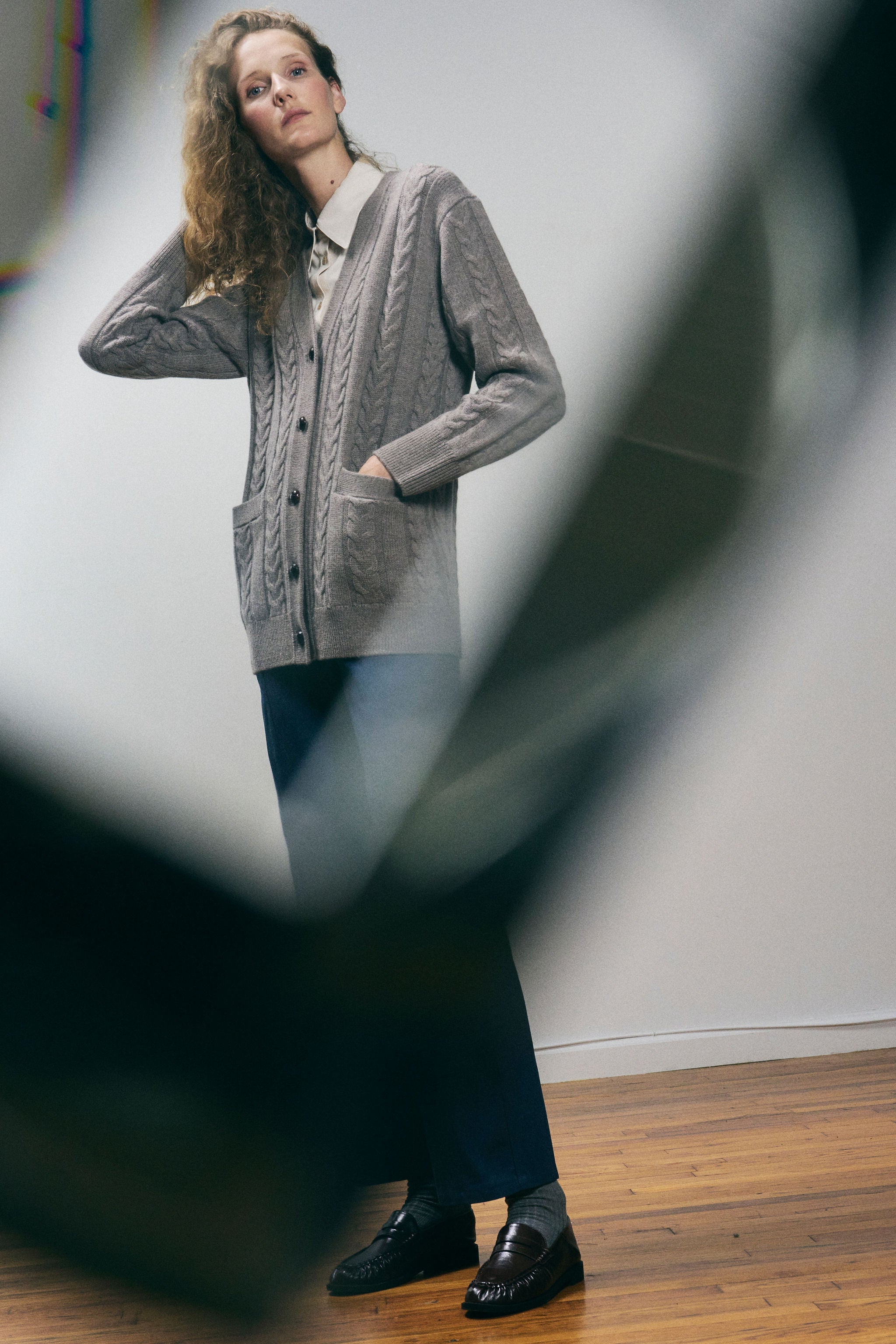 Sanmiguelito cardigan in Heather Brown — 100% Extrafine Merino wool, horseshoe cable and rib knit pattern, dropped shoulder, ribbed cuffs and hem, dark brown leather buttons, below-waist length, lifestyle editorial