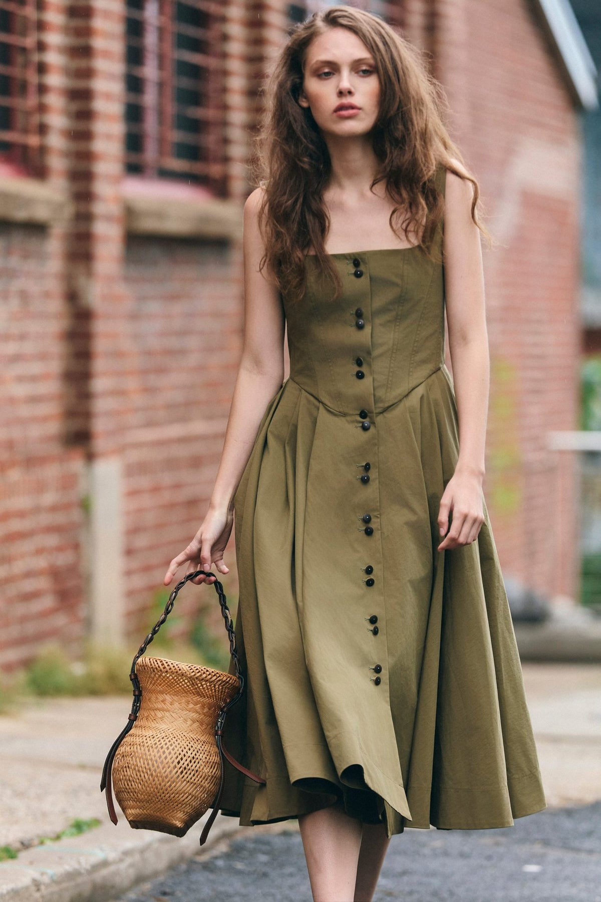 Woman wearing the Stathe Toloache Dress in Mosswood on a New York street — editorial