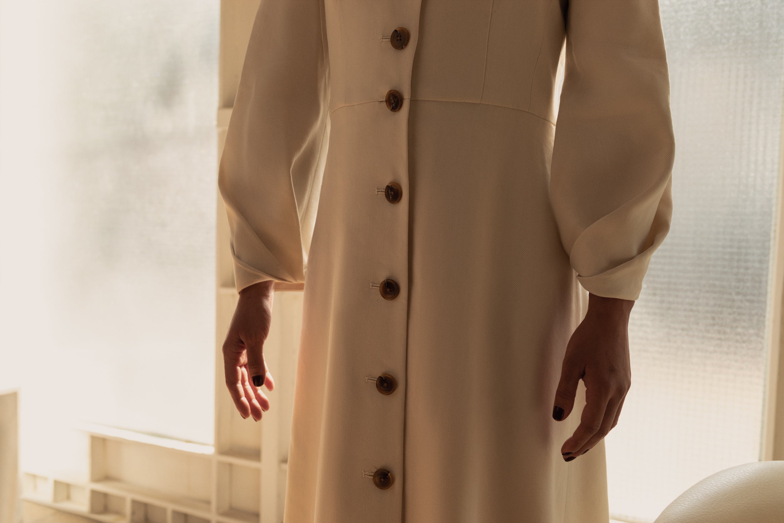 Alamo Dress in Alabaster — sleek Italian linen twill with slight natural stretch, seamed natural waist, sculpted three-quarter sleeves, button-front closure, above-ankle length, fabric detail